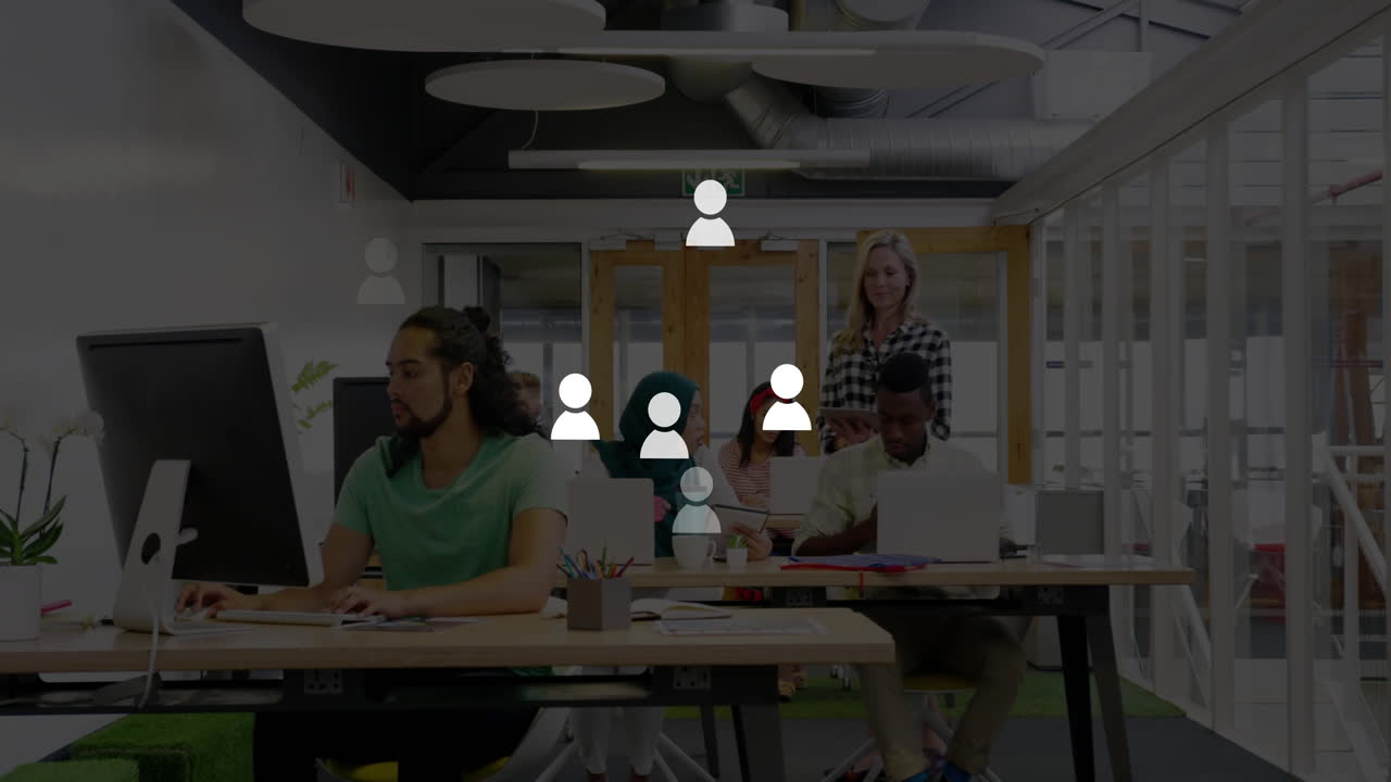 Coworkers collaborating in business office, with floating charts over desks and computers
