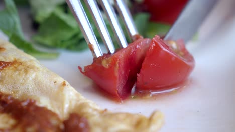 close-up of omelette with tomato and salad