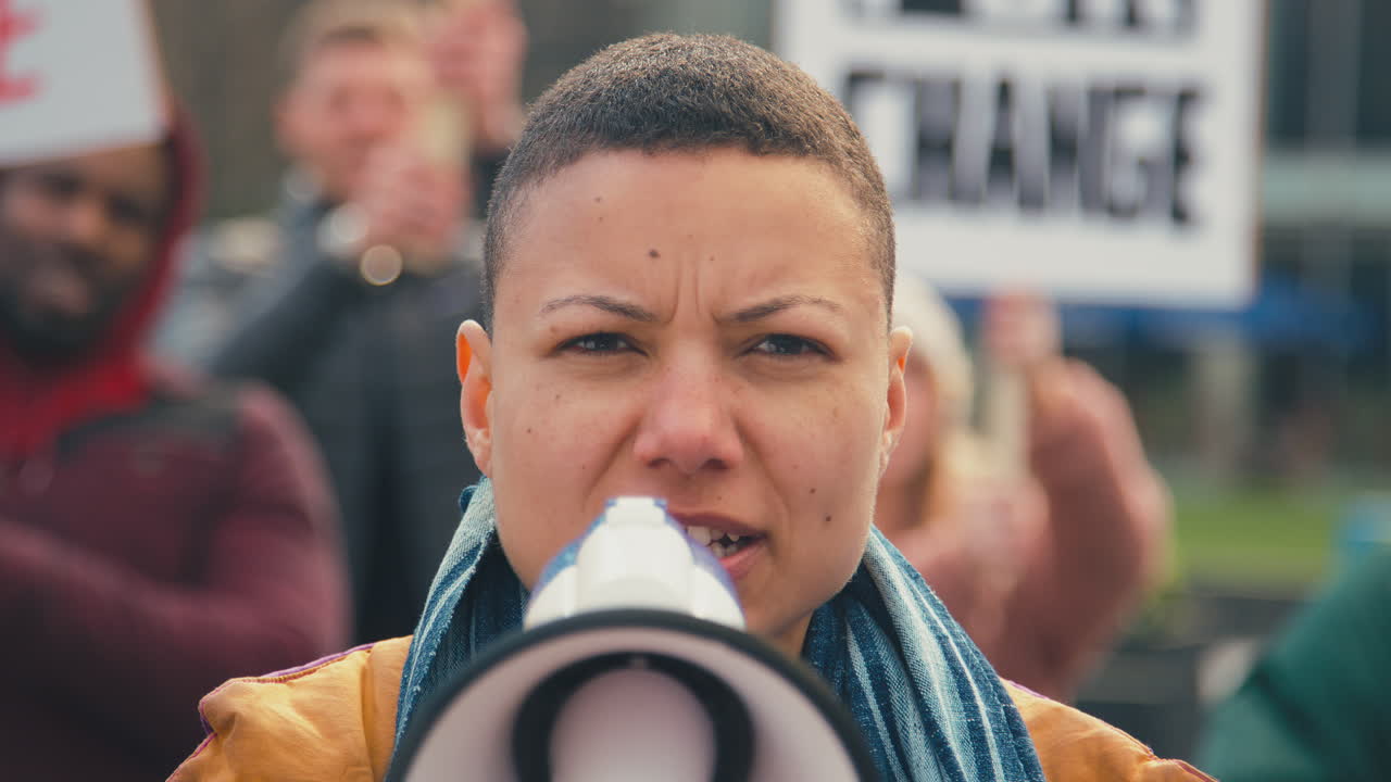 기후 변화에 반대하는 시위 행진에서 플래카드와 메가폰을 들고 있는 시위대