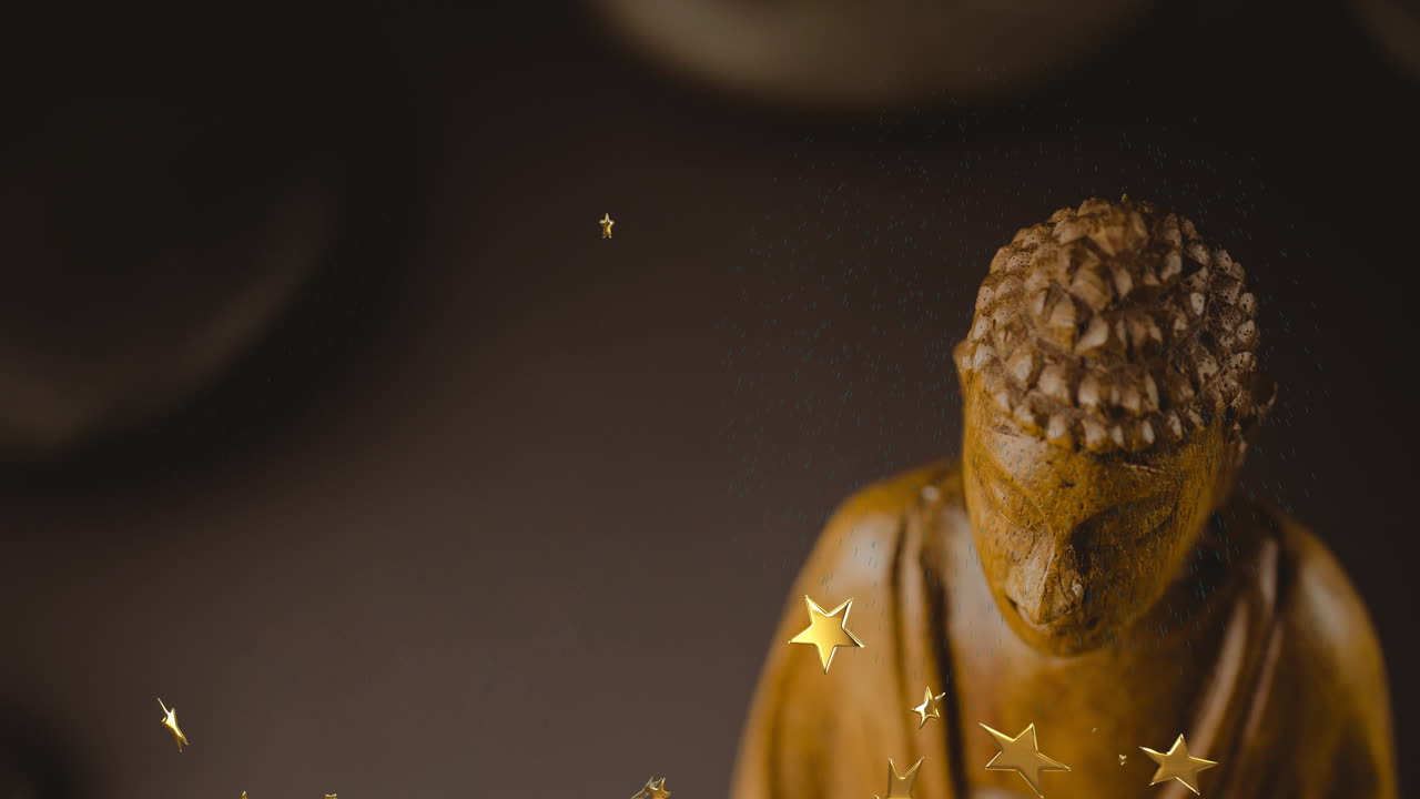 Floating stars and gentle light particles around golden Buddha statue in animation