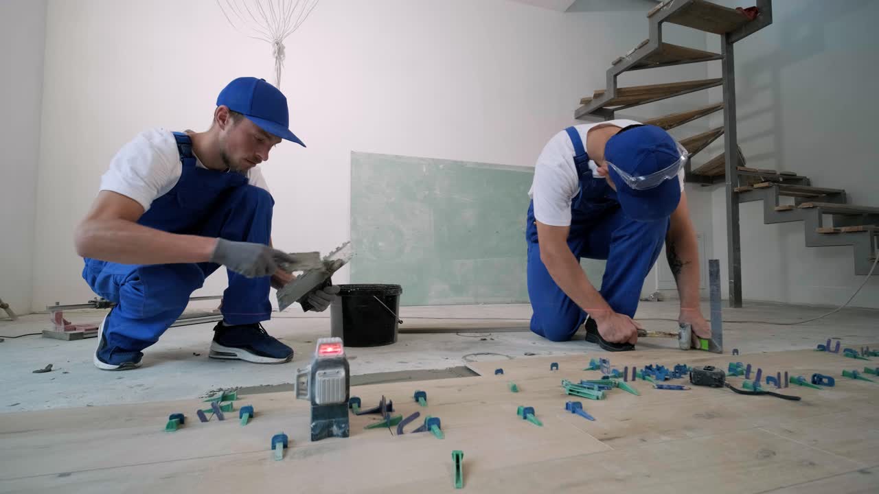 Installing ceramic floor tiles - measuring and cutting the pieces. Construction, renovation, repair apartment. Cuts tile. Tile cutting