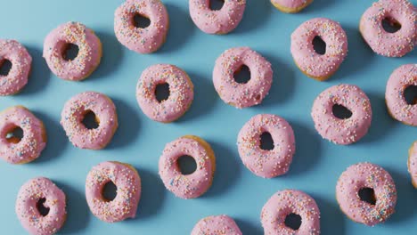 Video-of-donuts-with-icing-on-blue-background