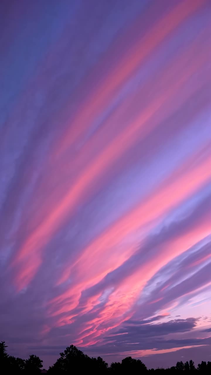 Vibrant sunset sky with pink streaks captured from a low angle, creating a dynamic and immersive