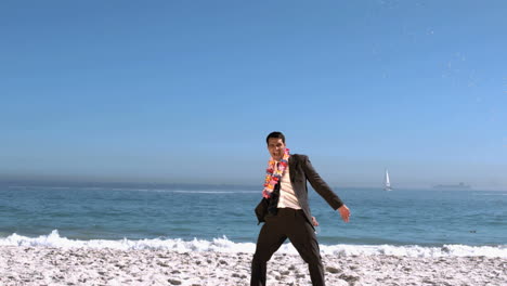 businessman on the beach throwing his cocktail glass