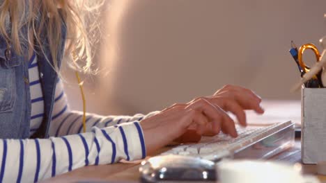 Hands-of-casual-businesswoman-using-computer