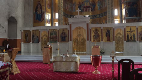 orthodox church interior with iconostasis and mosaics
