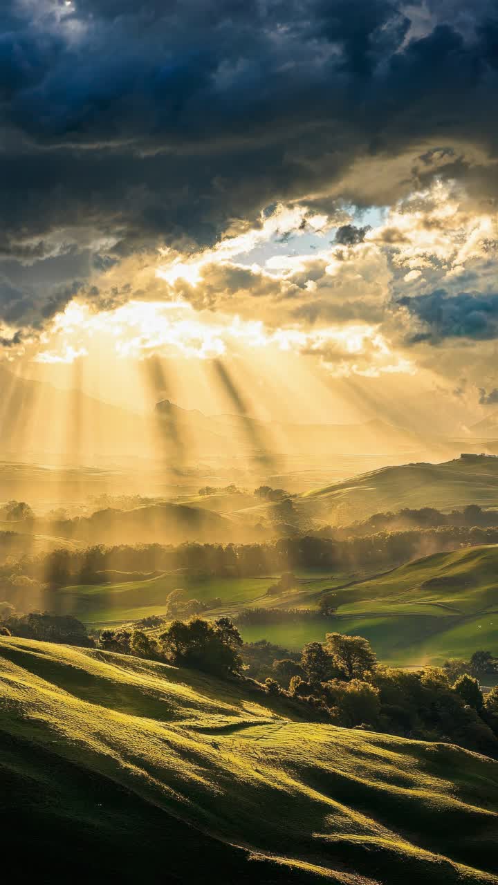 Aerial view of a sunlit landscape with rolling hills and dramatic clouds, capturing a serene