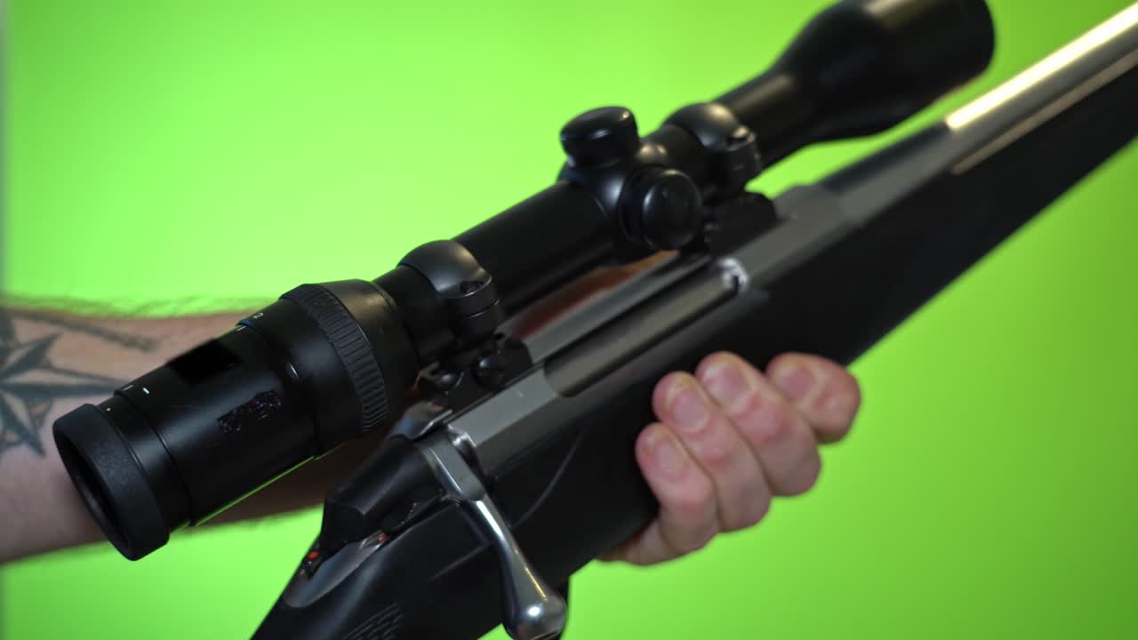 Reloading rifle by pulling back endpiece and putting new cartridge into chamber - 24fps green screen chroma key
