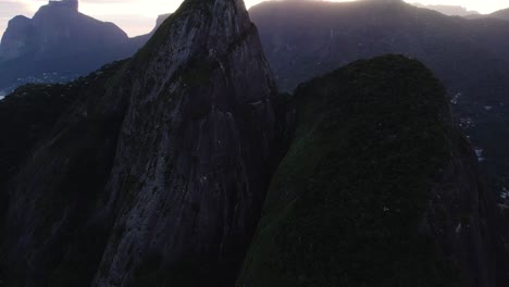 Drone-shot-around-the-Don-Irmaos-mountain-with-favela-da-Rocinha-background,-sunset-in-Rio,-Brazil