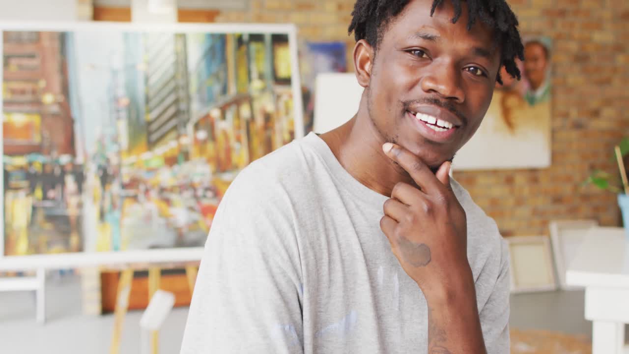 Portrait of smiling african american male painter in artist studio