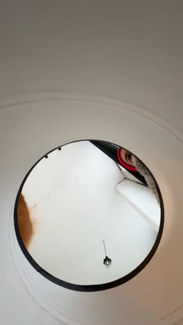 person walking through a circular hole in the ceiling