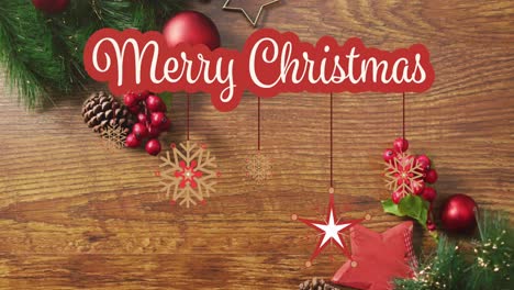 Animation-of-merry-christmas-text-over-christmas-decorations