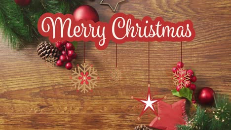 animación del texto de feliz navidad sobre las decoraciones navideñas