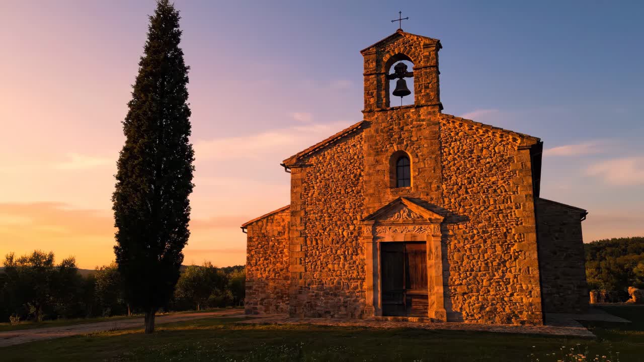 Stone church in the Tuscan countryside at sunset