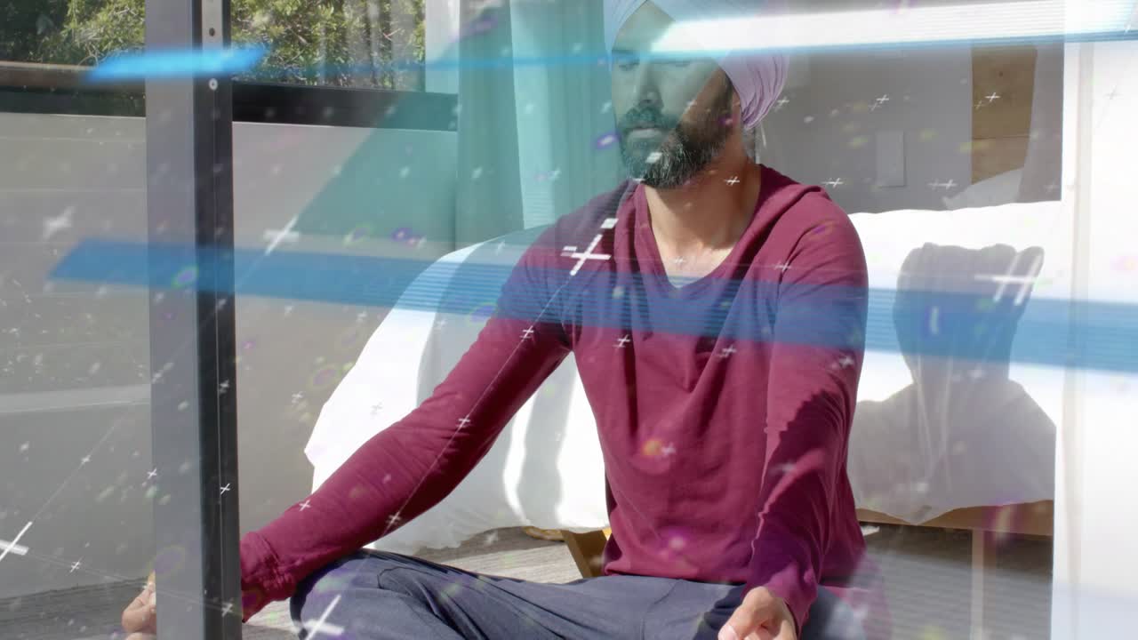 Man sitting by glass door, starting eyes closed, breathing for health, sparkles passing over frame