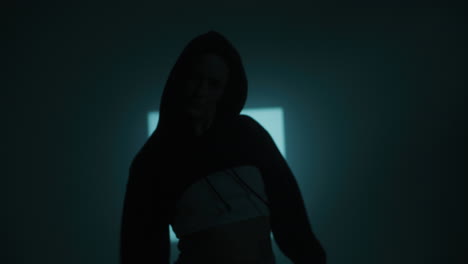 stylish woman posing in a dark studio