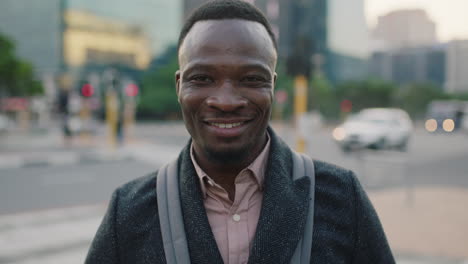 portrait of confident young african american businessman smiling enjoying successful lifestyle on busy urban city street