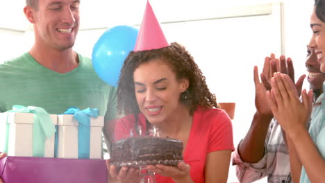 casual businesswoman blowing her birthday cake