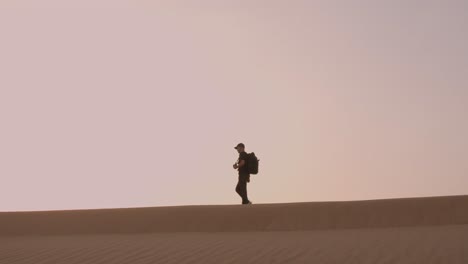 Cinematic-view-of-man-walking-in-the-desert