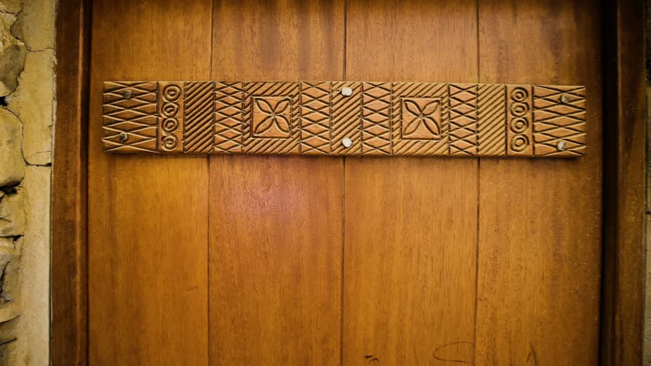 Establishing shot of antique wooden door in Thee Ain village Saudi Arabia, old carpentry design