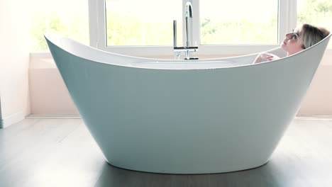 woman relaxing in a modern bathtub