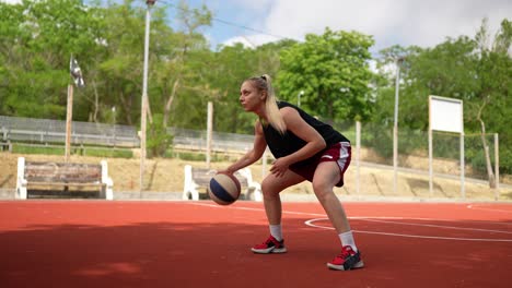 woman playing basketball outdoors