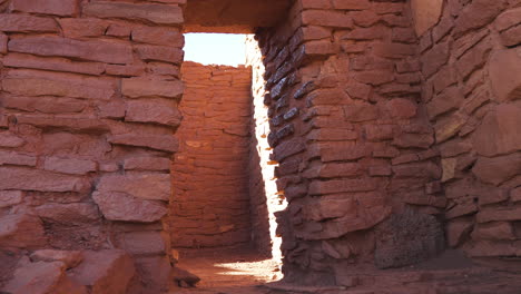 Track-in-shot-of-doorway-inside-ruins-of-Wukoki-Pueblo