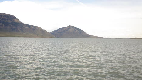 vast lake with mountains and expansive sky