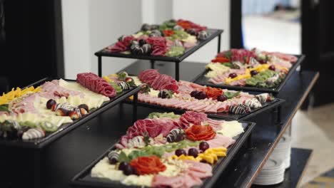 Charcuterie-board-with-different-fruits,-cheeses-and-hams-at-a-wedding-or-business-banquet