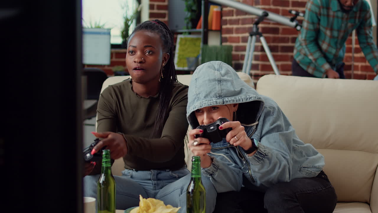 Diverse team of women playing video games on tv console