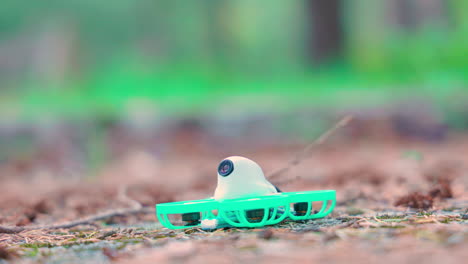 close shot of a little tinywhoop fpv drone taking off from the ground