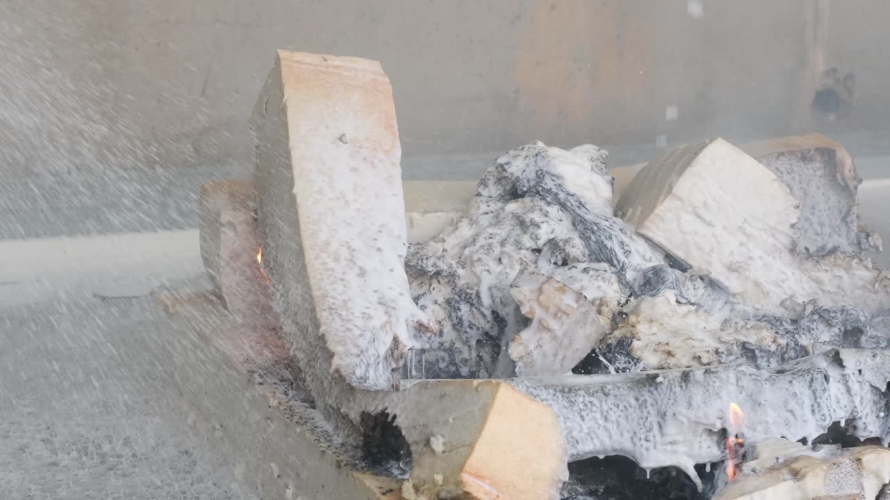 Firefighter and Sprinkler Working Together to Extinguish Flames