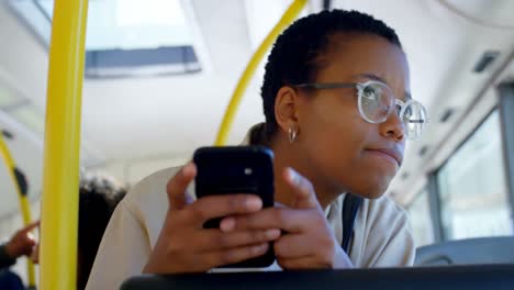 Female-commuter-using-mobile-phone-while-travelling-in-bus-4k