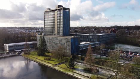 aerial descending view pilkington's glass head office, a modern blue high-rise with shared office space