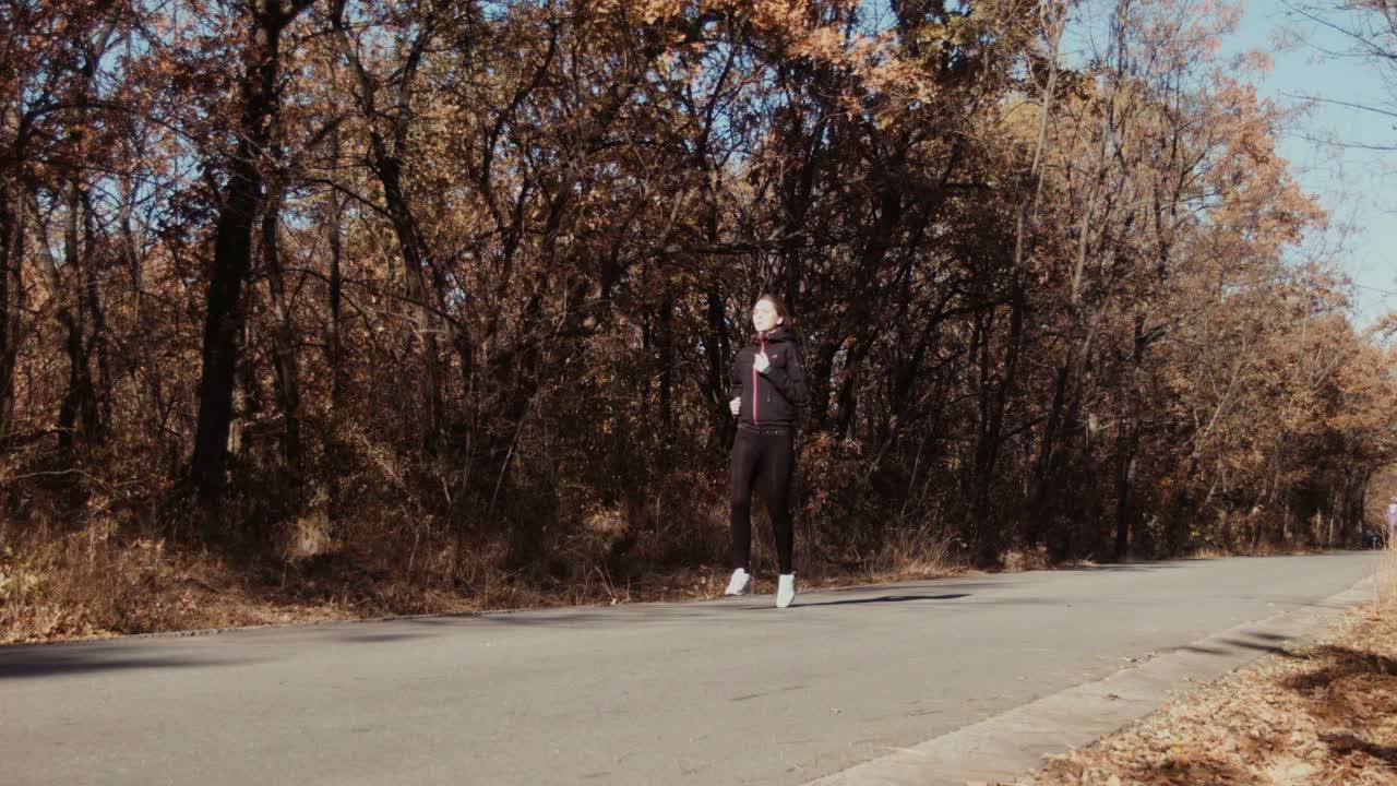 Girl Runs and Laughs with Bouquet Leaves in Autumn Park Child Plays Outdoors