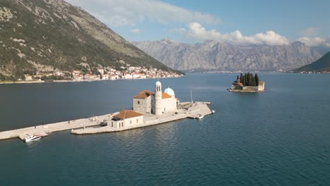 aerial pullback reveals our lady of the rocks in kotor bay, montenegro