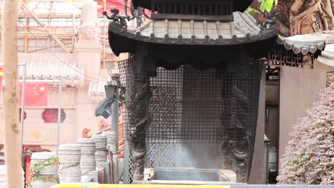 smoke rises from incense in hong kong temple