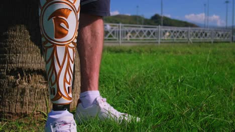 person with a prosthetic leg in a park