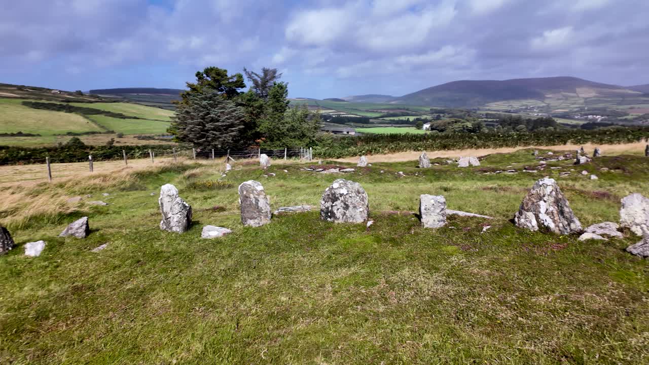 Ancient stone circle and settlement site at Braaid, Isle of Man, a historical landscape. panning shot