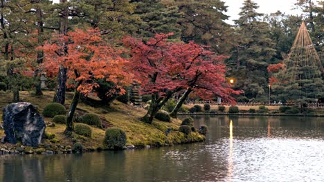 the iconic kenroku-en gardens in kanazawa glow beautifully under the warm hues of sunset.