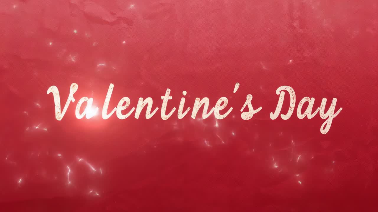 Opening title card introducing Valentine's Day script, pulsing on red creased paper, sparkles