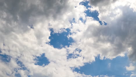 fluffy white and grey clouds in the atmosphere. formation of the cloudscape from low angle view. timelapse.