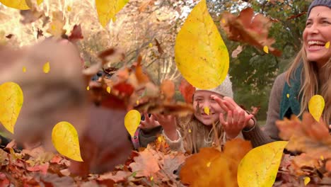 animation of fall leaves falling over happy caucasian family in autumn park