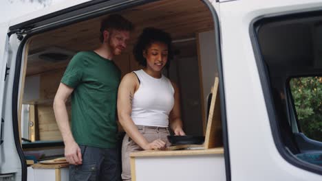 couple cooking in camper van