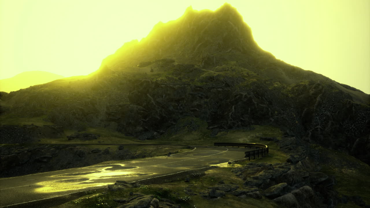 Mountain landscape with winding road under bright sunlight at dawn