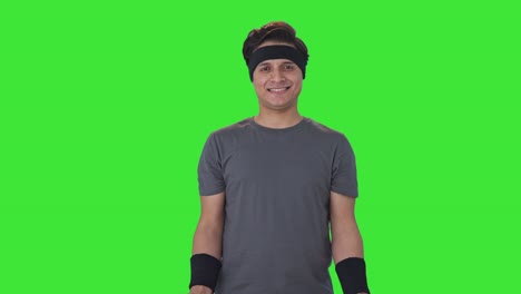 happy indian man lifting dumbells and doing exercise green screen