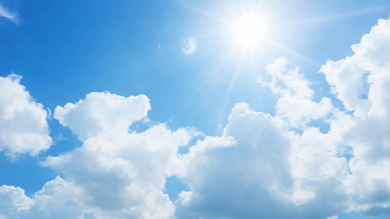A serene video of fluffy white clouds against a bright blue sky, captured from a low-angle