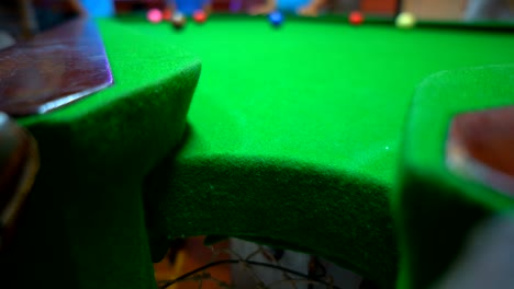 player playing snooker on green table on night for relaxing time