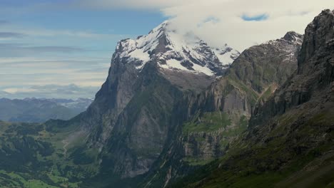 aerial view of the majestic snow-covered peak of the eiger in the bernese alps, soft clouds wrap around the summit