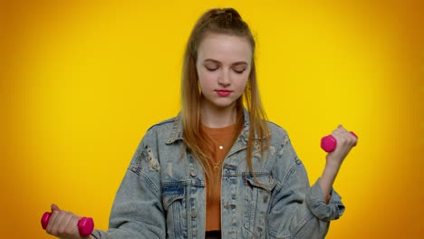 young woman lifting dumbbells